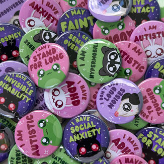 Various images of items Sketchy Frog Studio sells like communication button pins, shrimp keychains, reusable sticker books, stickers, tiny plush frogs, car magnet, book marks, phone charms